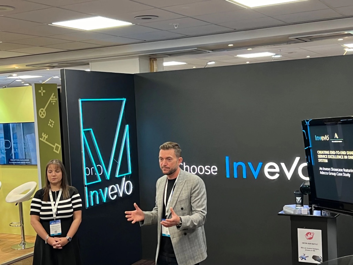 The Invevo stand: neon sign and video wall instead of a booth
